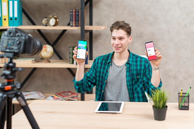 Mid Shot Blogger Holding Mock-Up Phones Psd