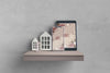Miniatures Of House On Shelf Beside Electronic Devices Psd