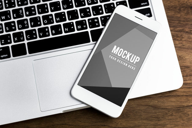 Mobile Phone On A Laptop Mockup Psd