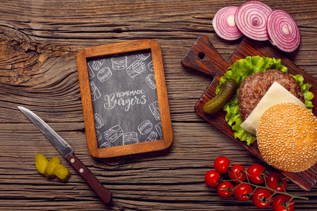 Mock-Up Chalkboard Frame With Burger On Wooden Background Psd