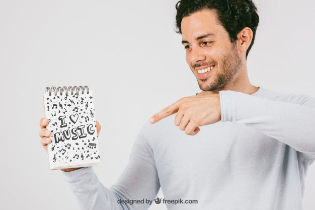 Mock Up Design With Smiley Man Pointing The Notebook Psd
