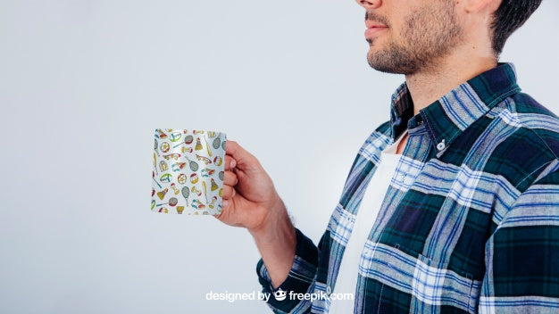 Mock Up Design With Young Guy Holding Coffee Mug Psd