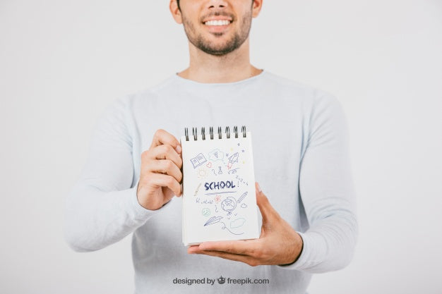 Mock Up Design With Young Man Holding Notebook Psd