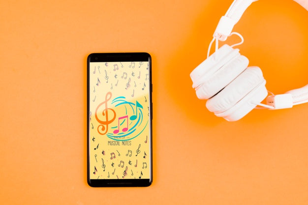 Mock-Up Headphones Beside Mobile Psd