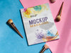 Mock Up Magazine Next To Makeup Brushes Psd