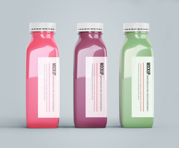 Mock-Up Plastic Bottles With Different Fruit Or Vegetable Juices Psd