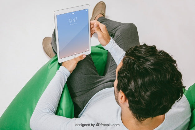 Mock Up With Man Relaxing With Tablet Psd