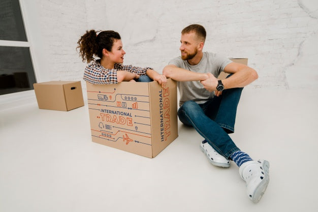 Mockup Of Couple With Cardboard Boxes Psd