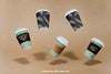 Mockup Of Flying Coffee Cups Psd