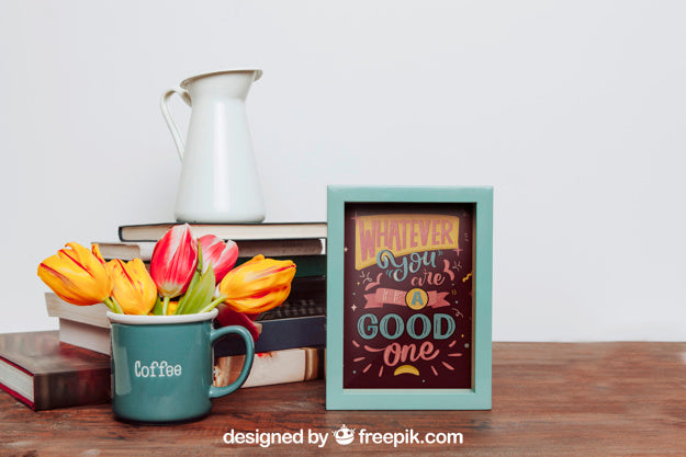 Mockup Of Frame Next To Flowers In Mug Psd