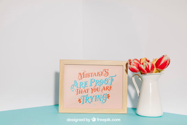 Mockup Of Frame Next To Red Flowers Psd