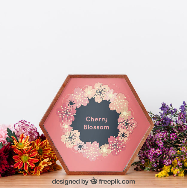 Mockup Of Hexagonal Frame Between Flowers Psd