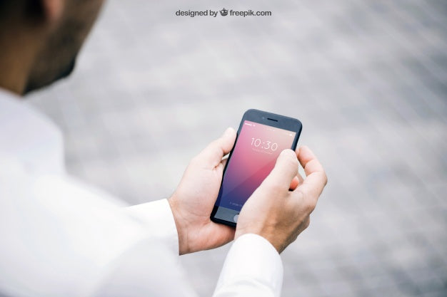 Mockup Of Man Looking At Smartphone Psd