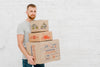 Mockup Of Man With Cardboard Boxes Psd