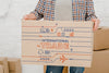 Mockup Of Man With Cardboard Boxes Psd