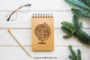 Mockup Of Notepad Next To Fir Branches Psd