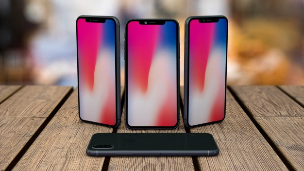 Mockup Of Smartphones On Tabletop Psd