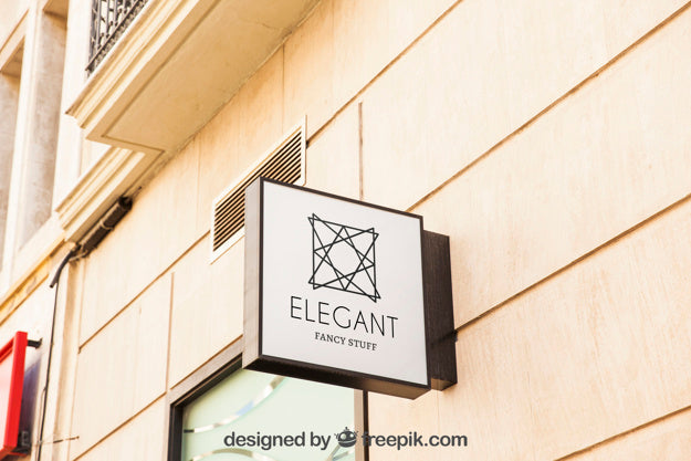 Mockup Of White Shop Sign On City Wall Psd