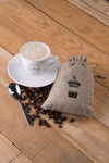 Mug With Bag Of Coffee Beans On Table Psd