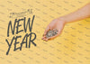 New Year Lettering With Person Holding Silver Confetti Psd