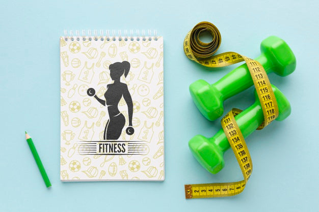 Notebook Beside Fitness Equipment Psd
