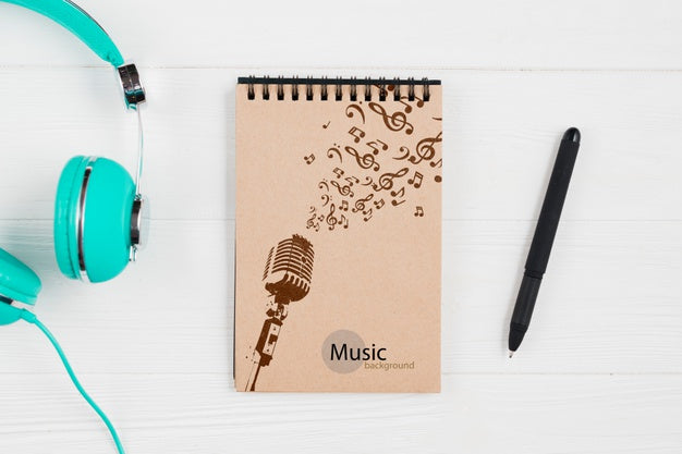 Notebook For Music Notes With Headphones Beside Psd