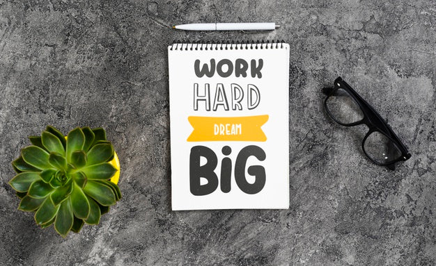 Notebook On Desk With Positive Message Psd