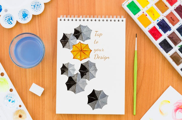 Notebook With Acrylic Pallette And Brush Beside Psd