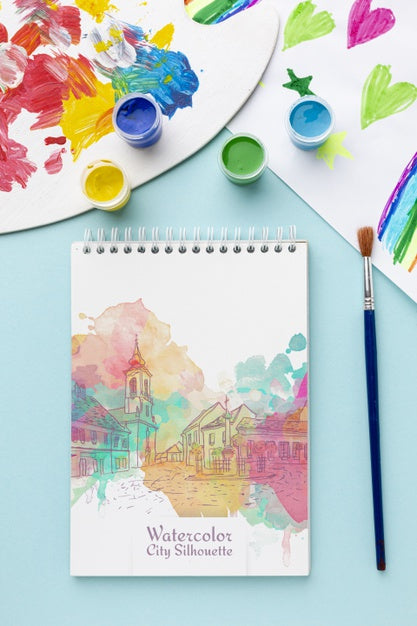 Notebook With Watercolors On Table Psd