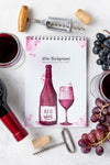 Notebook With Wine Bottle On Table Psd