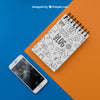 Notepad And Smartphone On Orange And Blue Background Psd