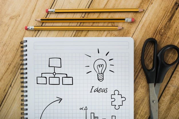 Notepad Mockup Next To Pencils And Sissors Psd