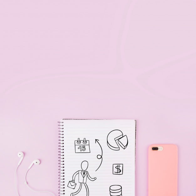 Notepad Mockup Next To Smartphone And Earphones Psd