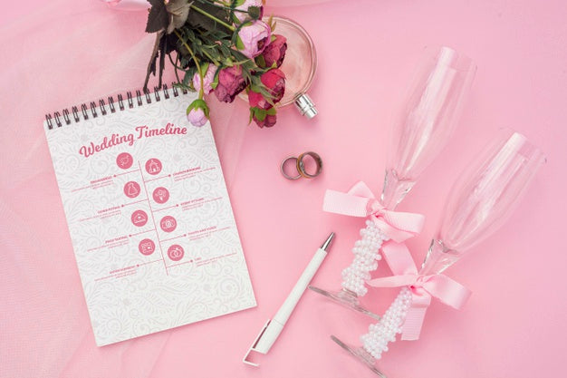 Notepad With Wedding Ideas And Glasses Of Champagne Psd