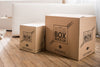 Packaging Box On Wooden Floor Psd Mockup