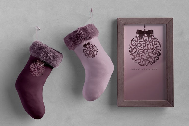 Pair Of Socks Beside Paint With Christmas Theme Psd