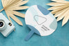 Paper Mock-Up Hand Fan With Dry Leaves And Camera Psd