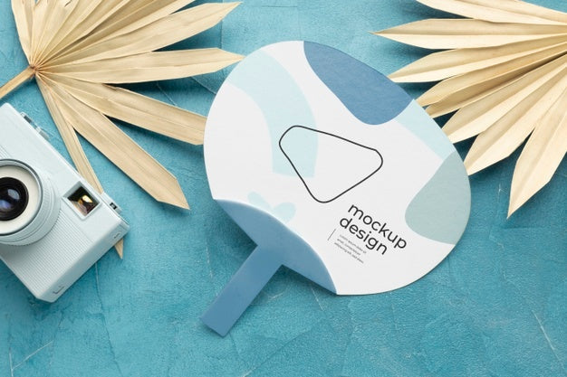 Paper Mock-Up Hand Fan With Dry Leaves And Camera Psd