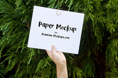 Empty White Paper in a Hand PSD Mockup