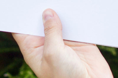 Empty White Paper in a Hand PSD Mockup
