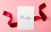 Paper Sheet With Red Ribbon Over Pink Surface Mockup Psd