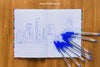 Pens And Notebook On Wooden Table Psd