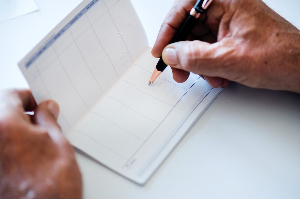 People Checking Bankbook Isolated On White Table