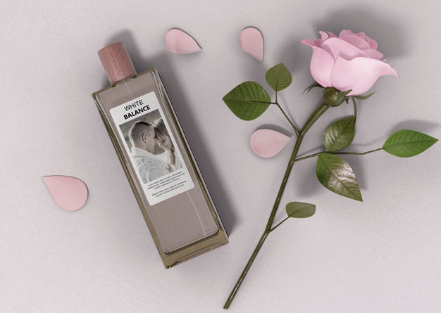 Perfume Bottle Beside Rose On Table Psd