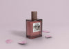 Perfume Bottle On Table With Petals Psd