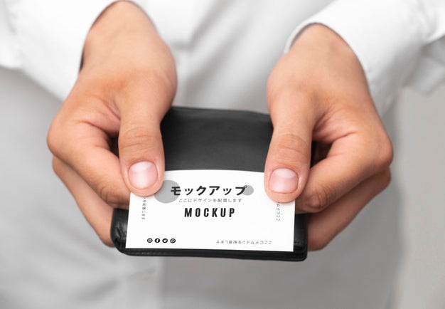Person Holding A Business Card Mock-Up Psd