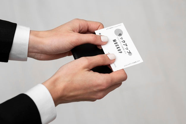 Person Holding A Business Card Mock-Up Psd