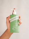 Person Holding A Liquid Soap Bottle Close-Up Psd