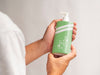 Person Holding A Liquid Soap Bottle Mock-Up Psd