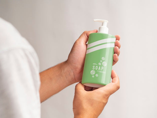 Person Holding A Liquid Soap Bottle Mock-Up Psd